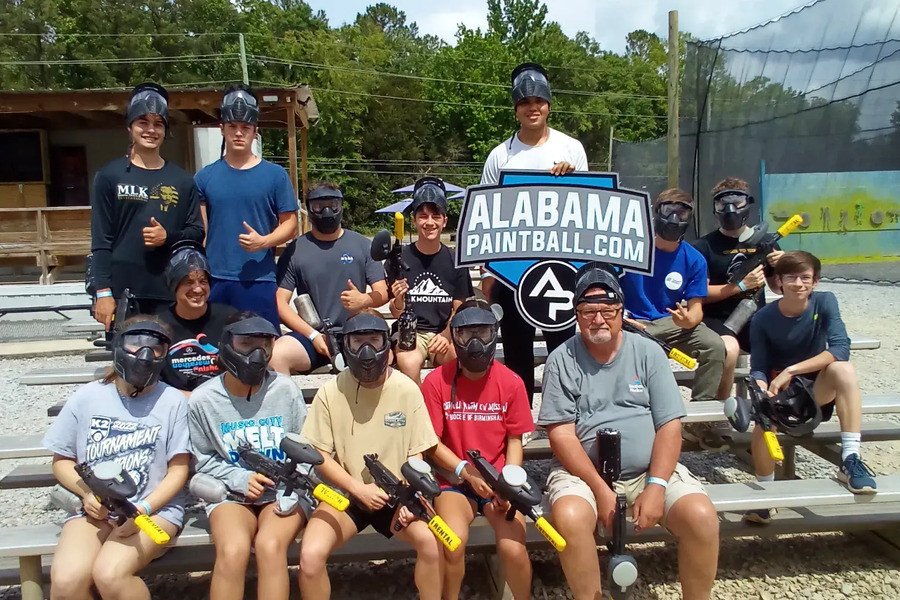 A youth group seated on the bleachers between games